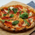 pizza with green leaves and red sauce